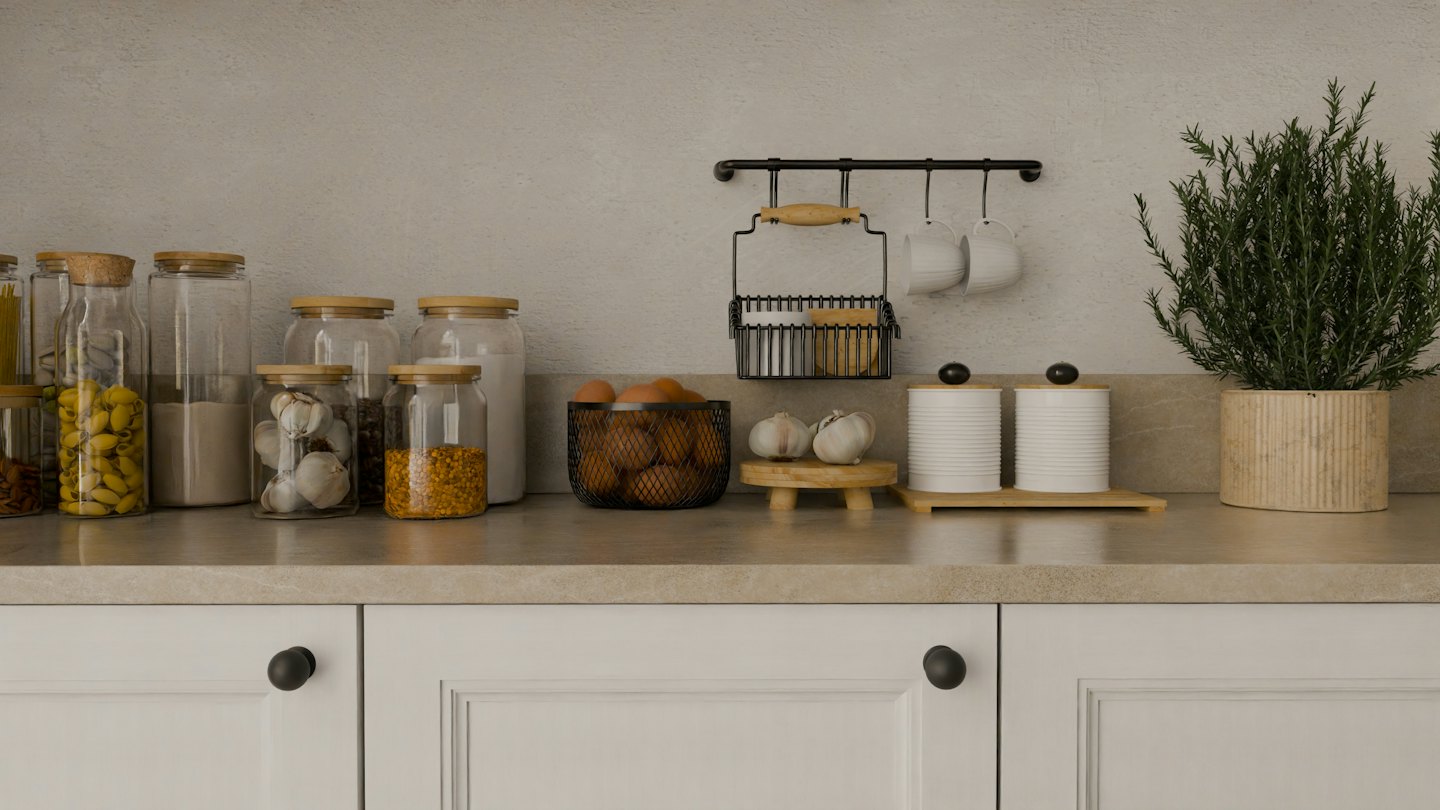 Kitchen counter with dry goods, eggs, and rosemary plant.